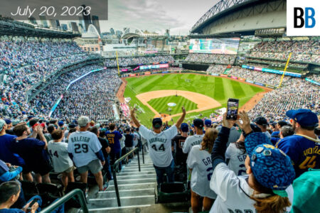 A crowd cheering at a baseball stadium.