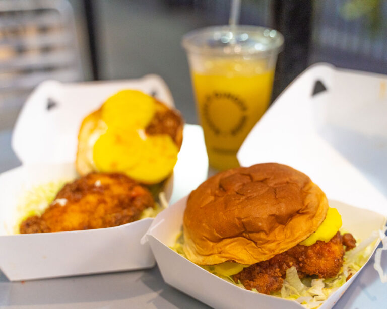 Sandwiches from Ma'ono and a glass of Rachel's Ginger Beer in take out packaging