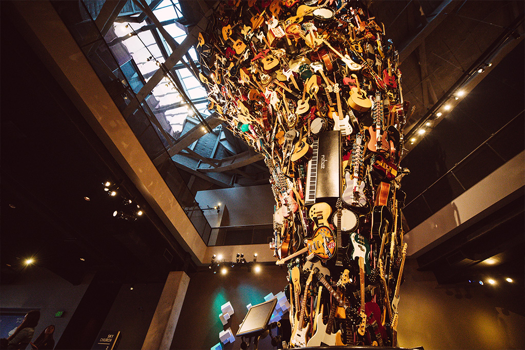 A photo of the guitar sculpture at the Museum of Pop Culture. The sculpture is created from dozens of guitars and some other instruments forming the shape of a tornado.