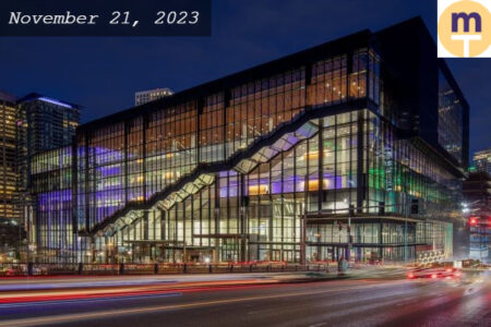 Street view of a big glass building taken during the evening time.