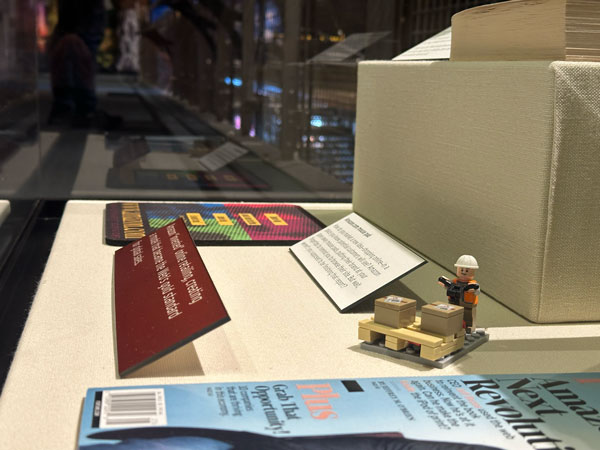 A LEGO minifig depicting a warehouse employee, hidden in the Amazon display at MOHAI.