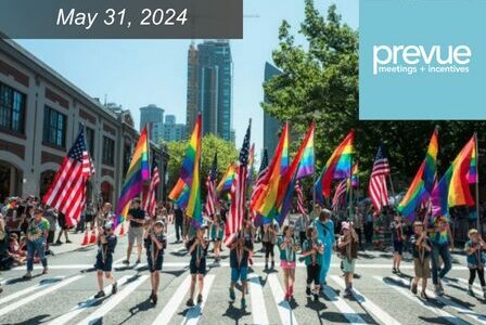 Group of kids raise Pride Flags in the middle of a Pride Parade.