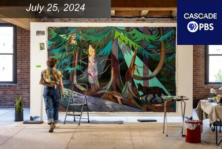 Kimberly Trowbridge walks toward a large mural of a forest and a wolf.