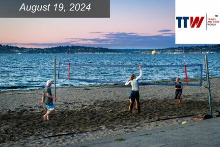 Beach volleyball players playing at Alki at sunset