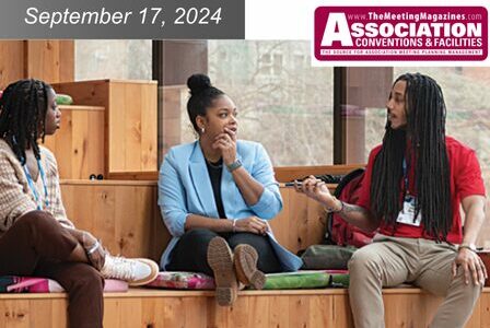 Three people are seated on wooden steps in Seattle Convention Center's Summit building, engaged in conversation.