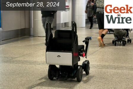 Self-driving, electric wheelchair navigating a concourse at the Seattle Airport