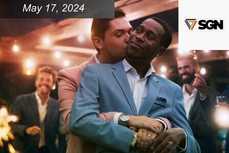 Couple embraces each other as people celebrate around them