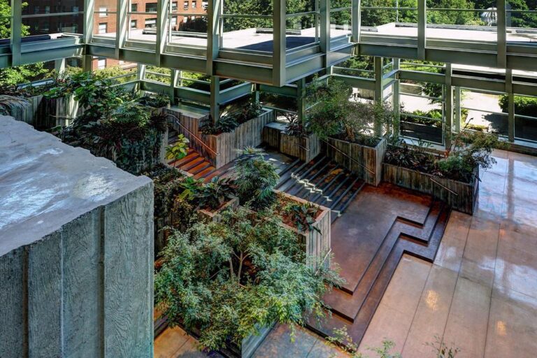 Building lobby with glass windows and green foliage in planters