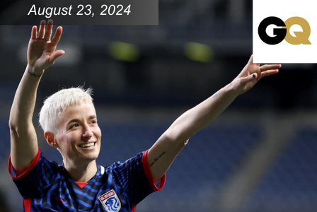 Megan Rapinoe with her arms in the air