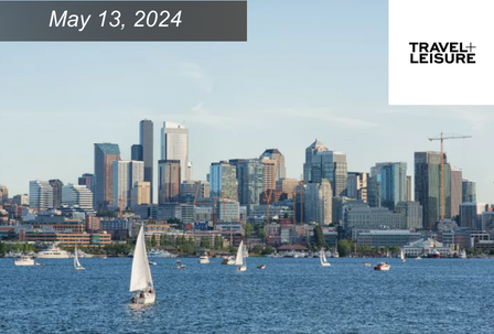 Sailboats on a lake with Seattle skyline behind