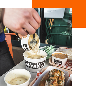 A hand pouring chowder at Pike Place Chowder