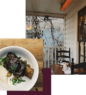 A cozy outdoor dining area with a wooden table set for two under a covered porch. The table is adorned with glassware and white napkins. An inset image shows a dish of braised short ribs with garnish, served on a white plate.