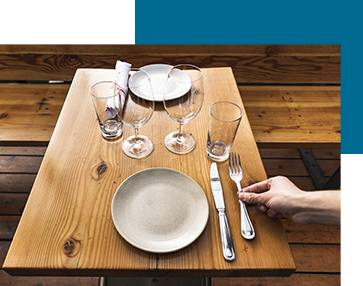 Hand placing fork in place setting at Marjorie