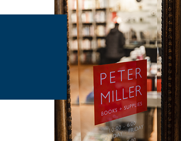 Exterior signage at Peter Miller, looking through the glass door toward the interior